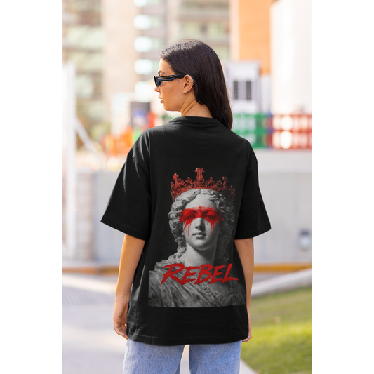 Lifestyle shot of model wearing black Rebel classical statue back graphic t-shirt, dark luxury streetwear tee featuring defaced marble sculpture with red paint across the eyes and bold rebellion-inspired artwork