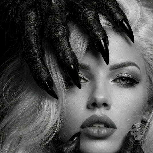 Close-up detail of black and white surreal woman portrait wall art featuring dark claw hands and high-contrast monochrome facial composition