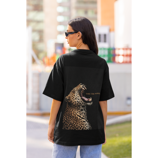 Black leopard back graphic t-shirt worn by model outdoors, roaring leopard artwork with TAKE THE WORLD text, luxury streetwear statement tee