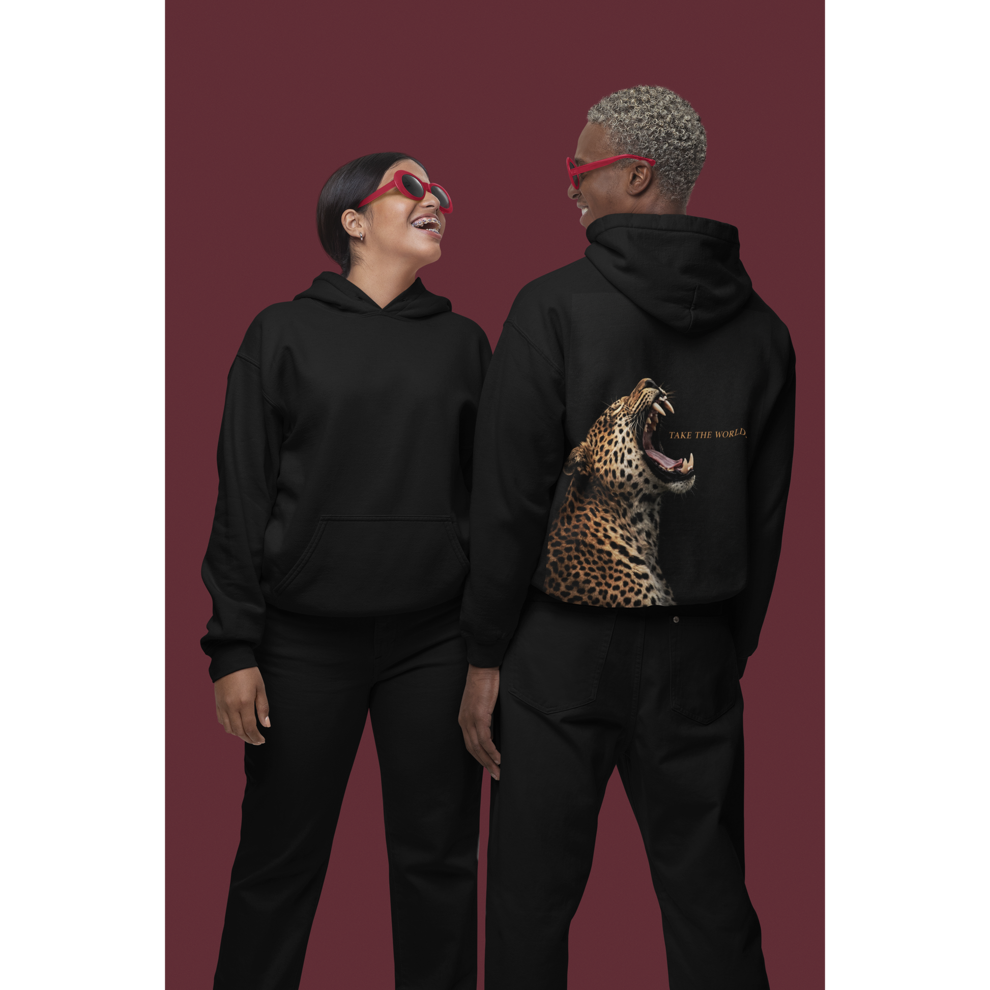 Black streetwear hoodie back view worn by couple featuring roaring leopard artwork and Take the World text, unisex luxury animal graphic hoodie