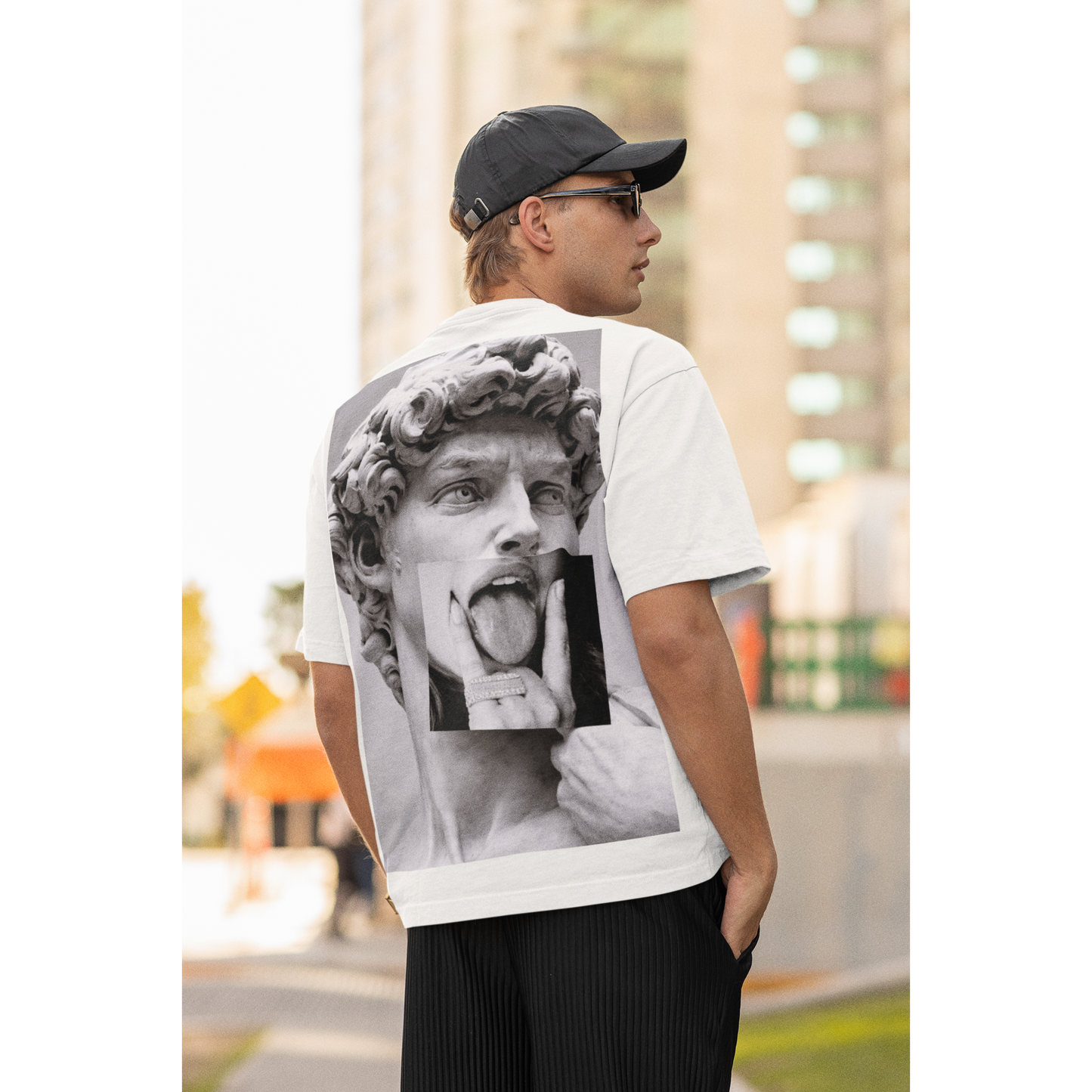 Male model wearing white graphic t-shirt with David statue grunge collage back artwork, urban gothic streetwear fashion, statement art t-shirt outfit