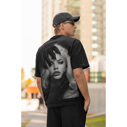 Male model wearing black dark feminine back graphic t-shirt outdoors, unisex gothic portrait statement tee featuring dark feminine portrait artwork printed on the back