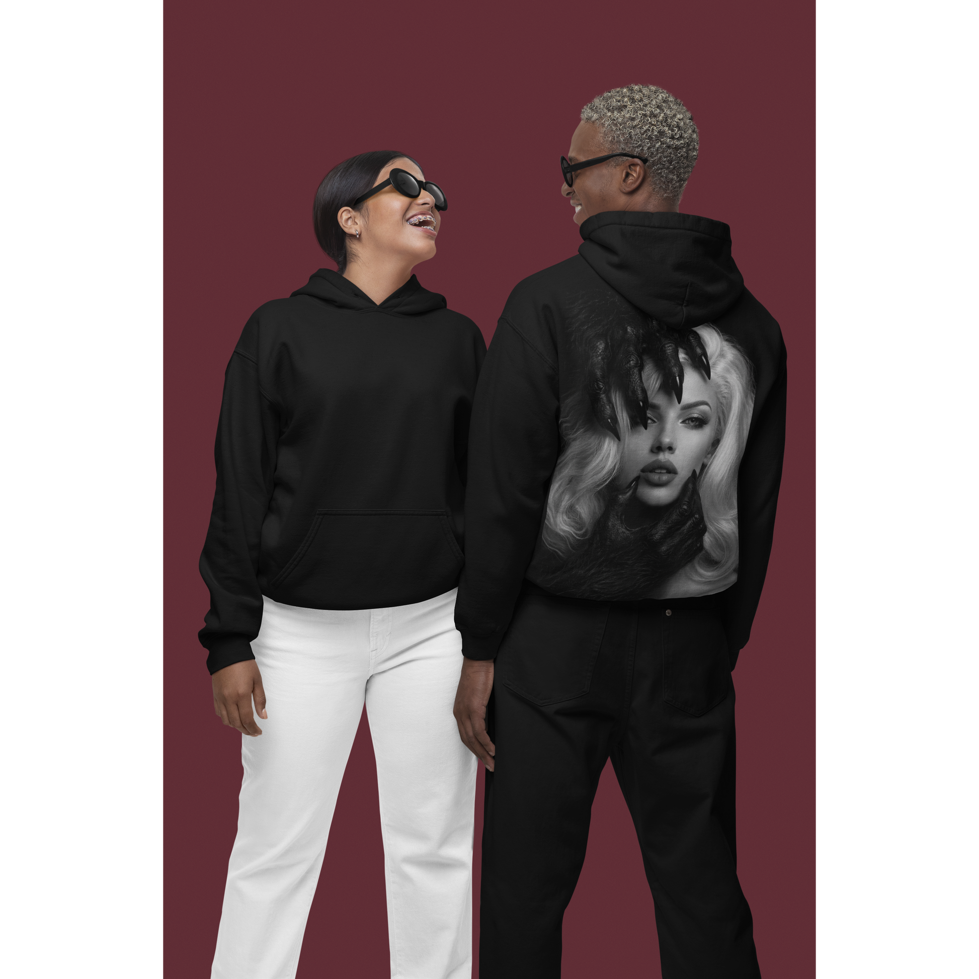 Male and female models wearing black dark feminine back graphic hoodie shown front and back, unisex gothic portrait statement hoodie with clean front and bold back artwork
