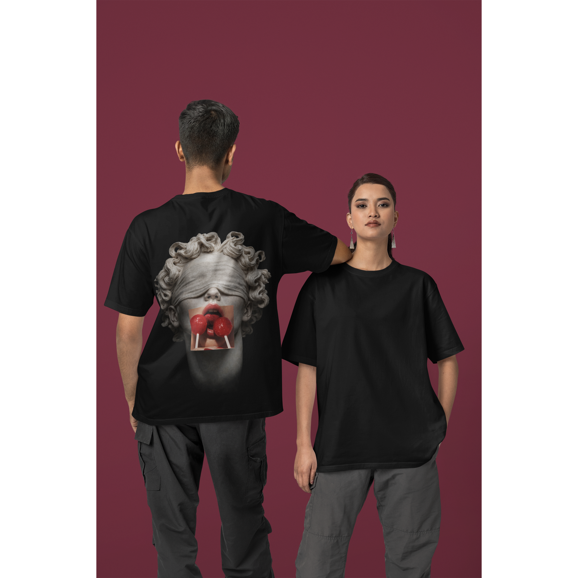 Two models wearing black t-shirts with blindfolded classical statue back graphic, surreal marble sculpture with red lollipops, unisex streetwear