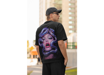 Black surreal serpent glamour back graphic t-shirt worn by model outdoors, dark luxury streetwear tee showcasing bold iridescent snake and modern portrait artwork on the back