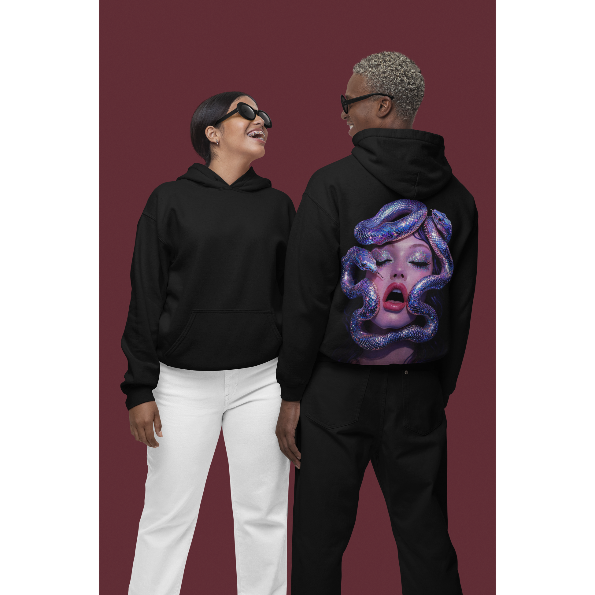 Black unisex hoodies worn by models showing surreal serpent glamour back graphic, dark luxury streetwear with iridescent snake artwork