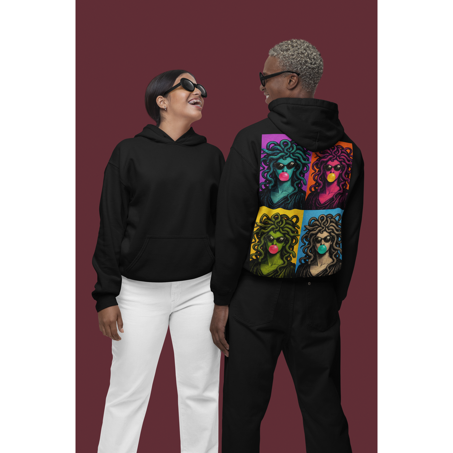 Black pop art Medusa back graphic hoodie worn by two models in studio setting, unisex bold statement hoodie featuring clean minimalist front design and vibrant pop art Medusa collage artwork printed on the back