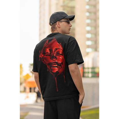 Male model wearing black red liquid face back graphic t-shirt, dark luxury streetwear tee featuring high-gloss red fluid face artwork with dripping details on unisex black t-shirt in outdoor urban setting