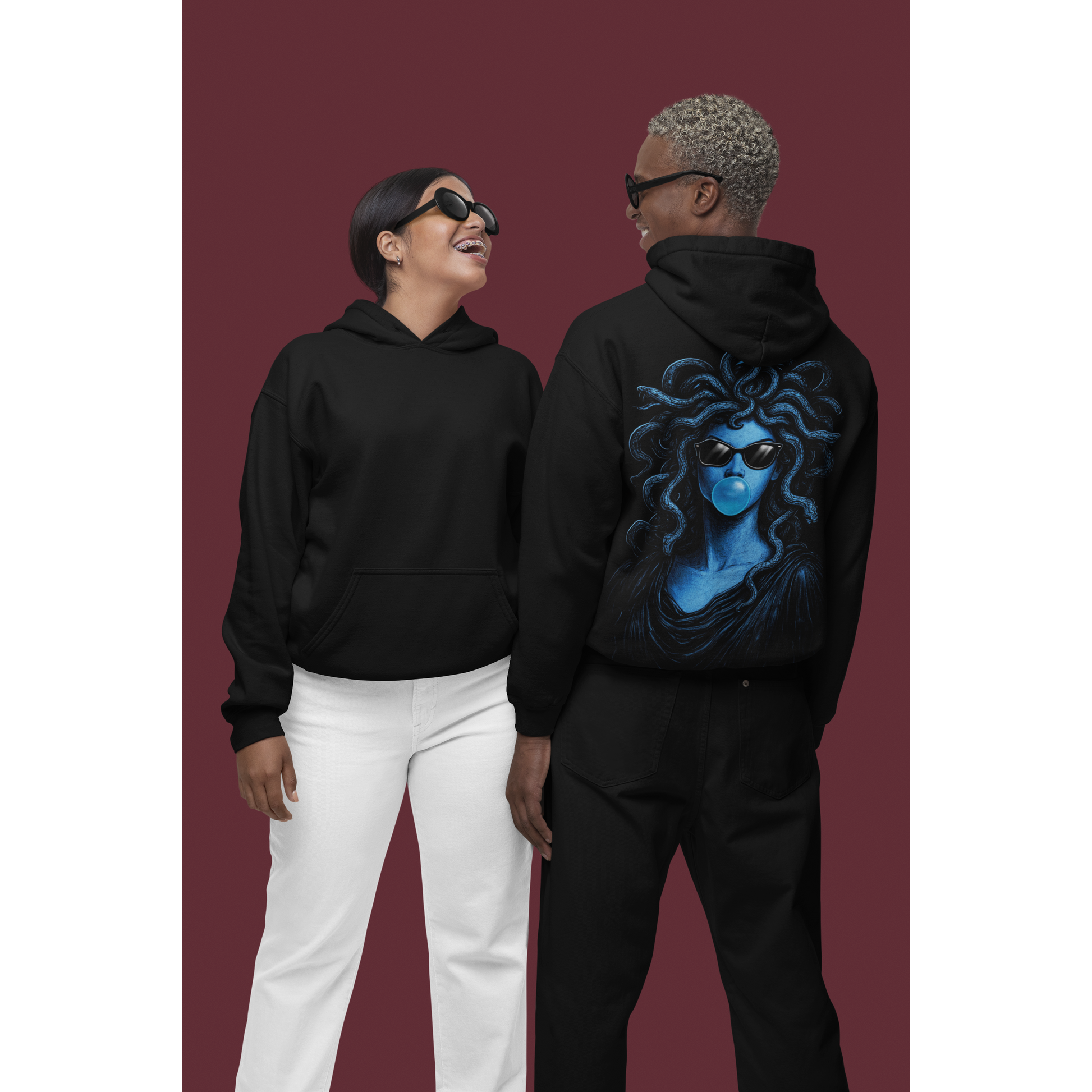 Male and female models wearing black blue medusa bubblegum back graphic hoodies shown front and back, dark luxury streetwear hoodies featuring blue Medusa artwork with sunglasses and bubblegum and clean minimalist front