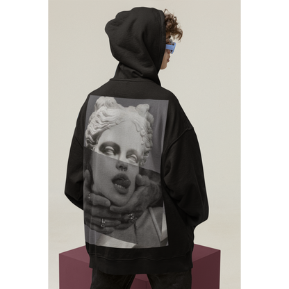 Black surreal statue back graphic hoodie shown in studio with hood up, unisex premium streetwear hoodie featuring surreal classical statue collage artwork printed on the back and clean front silhouette