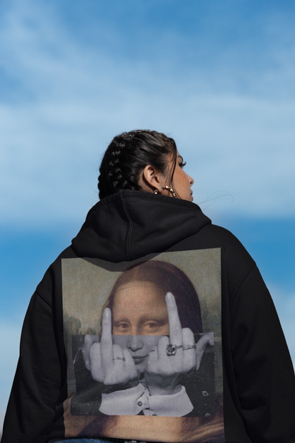 Person wearing a black hoodie with a Mona Lisa graphic making a peace sign against a blue sky.