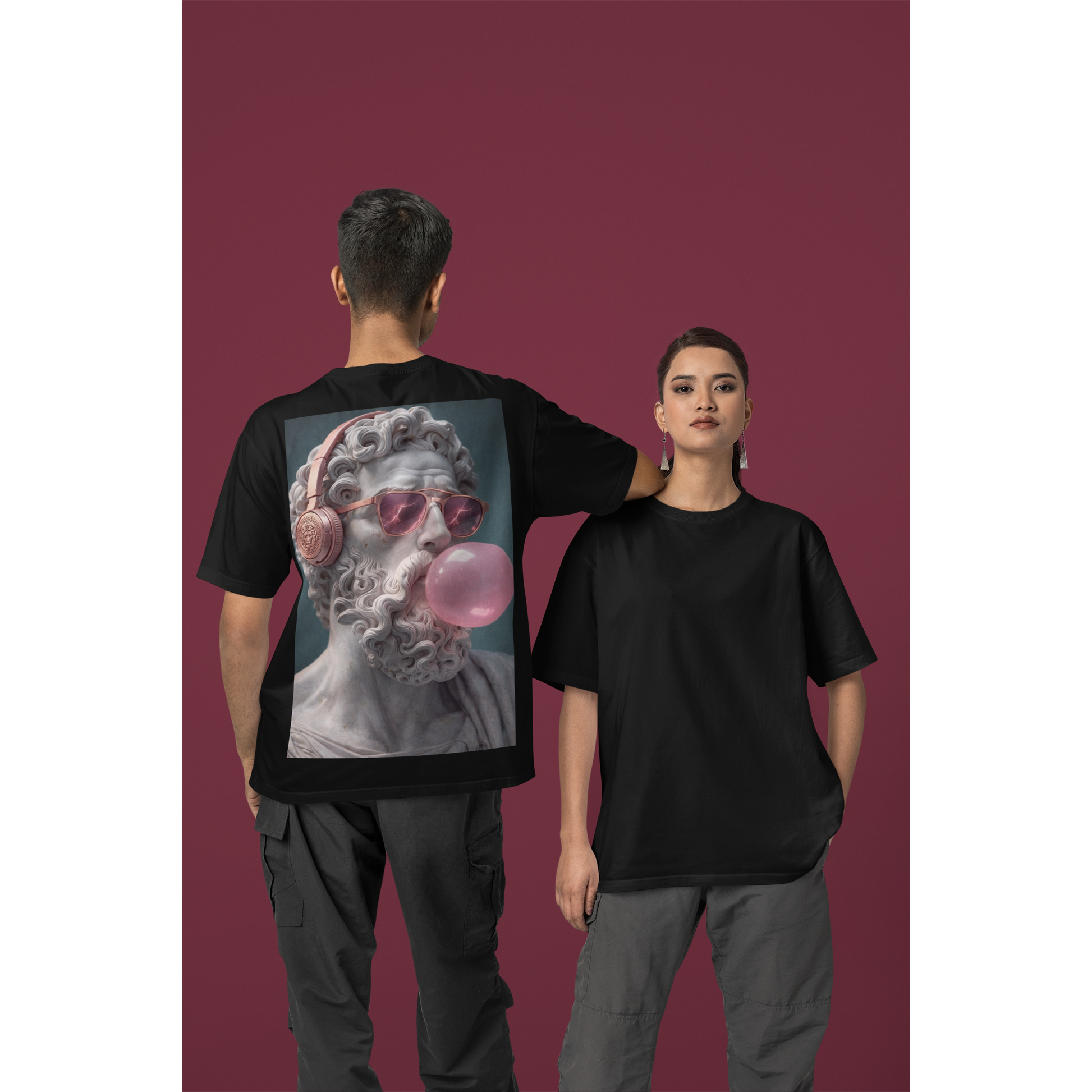 Unisex black classical statue headphones bubblegum back graphic t-shirt shown on male and female models, dark luxury streetwear tee featuring marble statue wearing headphones and blowing pink bubblegum with clean minimalist front and bold back artwork