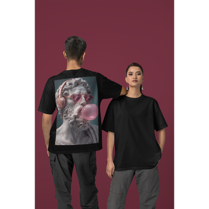 Unisex black classical statue headphones bubblegum back graphic t-shirt shown on male and female models, dark luxury streetwear tee featuring marble statue wearing headphones and blowing pink bubblegum with clean minimalist front and bold back artwork