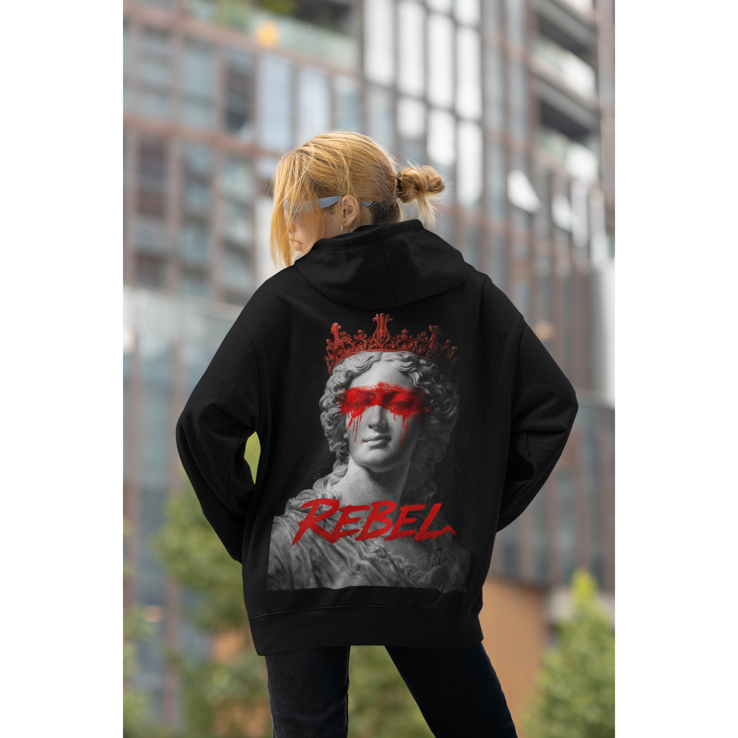 Black rebel hoodie worn in urban setting, classical marble statue red paint back graphic streetwear hoodie styled for modern rebellion