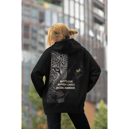 Model wearing black unisex hoodie with leopard panther back graphic and motivational quote dark luxury streetwear worn in urban city environment