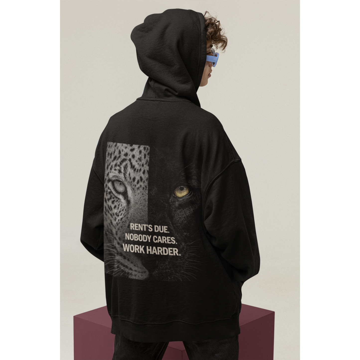 Unisex black pullover hoodie worn by model showing split leopard panther back artwork and discipline quote dark luxury statement hoodie