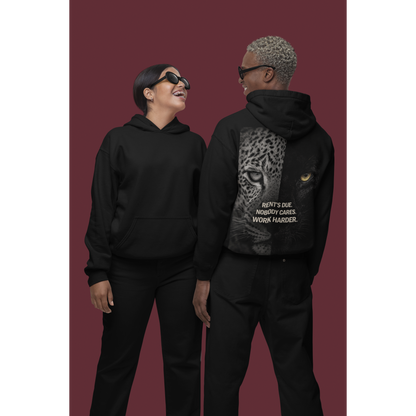 Two models wearing black unisex pullover hoodies featuring clean front and leopard panther back graphic with “Rent’s Due. Nobody Cares. Work Harder.” statement