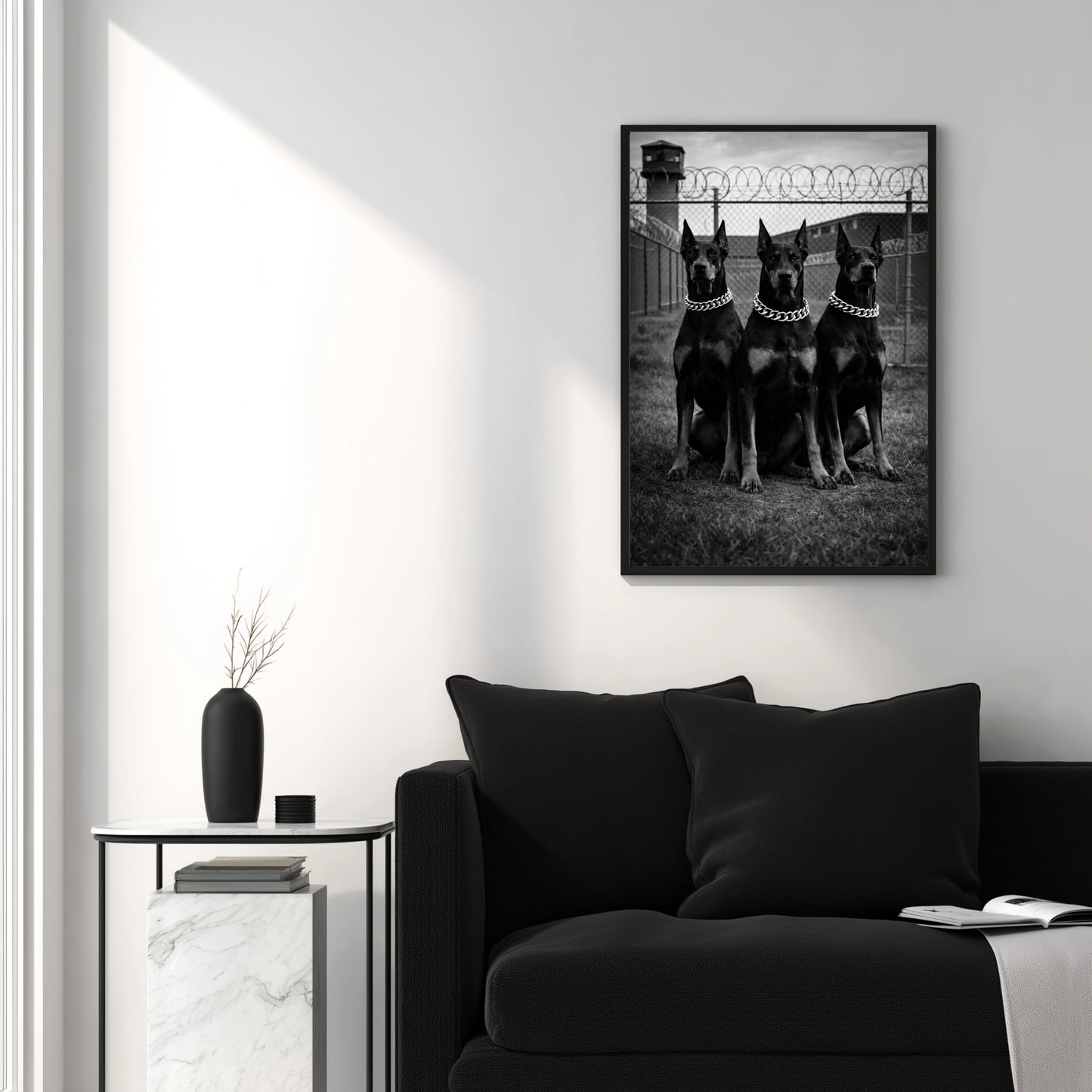 Black and white Doberman trio wall art above black sofa in minimalist living room, modern monochrome dog print decor