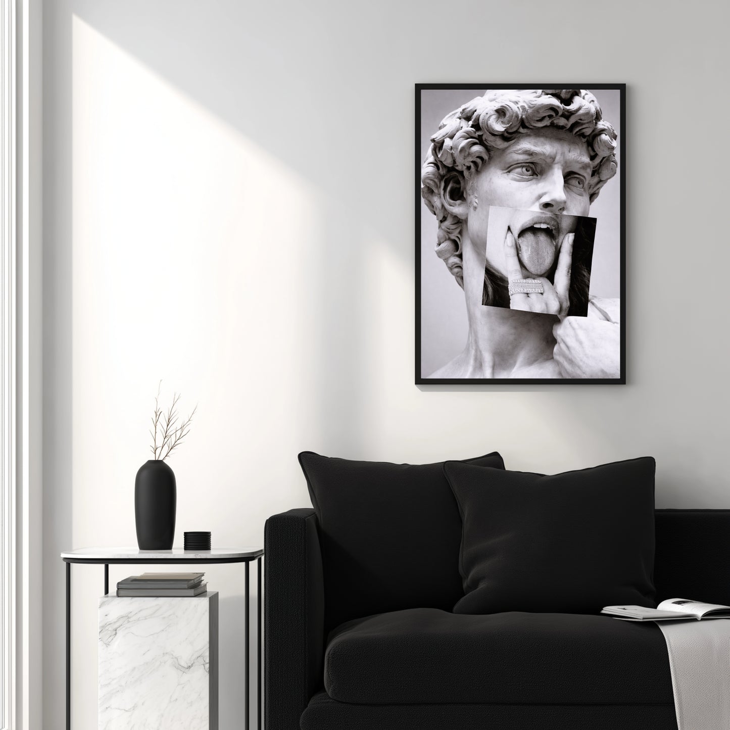 Classical sculpture collage wall art above black sofa in modern white living room, contemporary statement wall decor