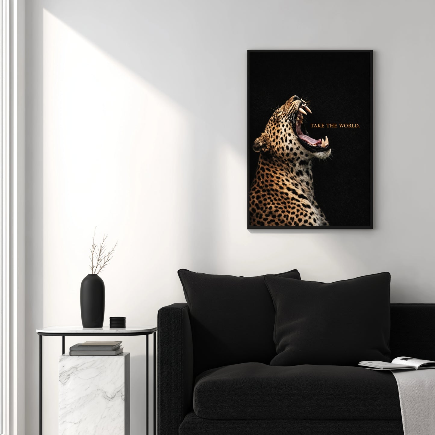 Leopard Take the World wall art above black sofa in modern white living room, motivational wildlife statement artwork decor