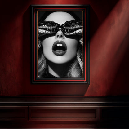 Black and white serpent eye wall art displayed in dark frame on red interior wall, surreal snake portrait statement artwork for modern space