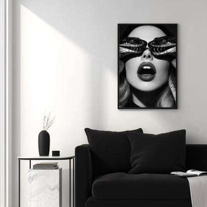 Contemporary black and white snake portrait wall art above black sofa in minimalist interior setting