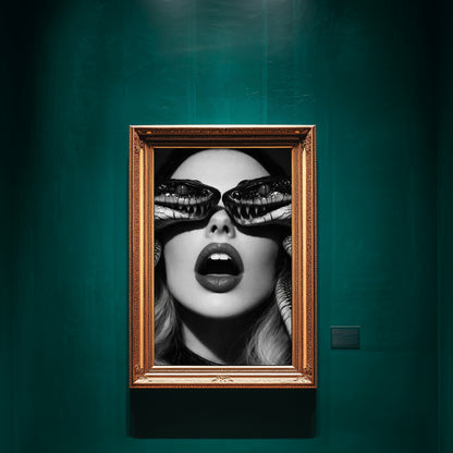 Surreal snake portrait wall art in ornate gold frame on deep green gallery wall featuring black and white female face with serpents covering eyes