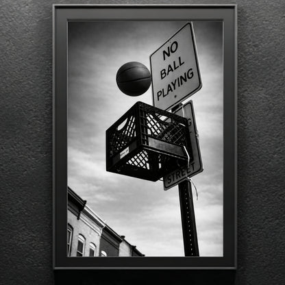 Close up black and white street basketball wall art in black frame, milk crate hoop mounted under no ball playing street sign urban photography print