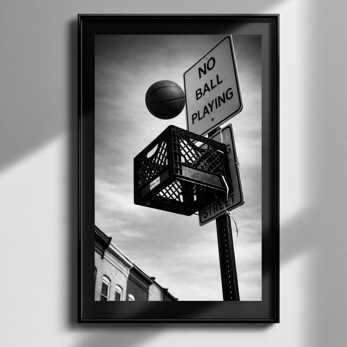 Framed black and white urban basketball artwork with soft light reflection, milk crate hoop and no ball playing sign modern monochrome decor