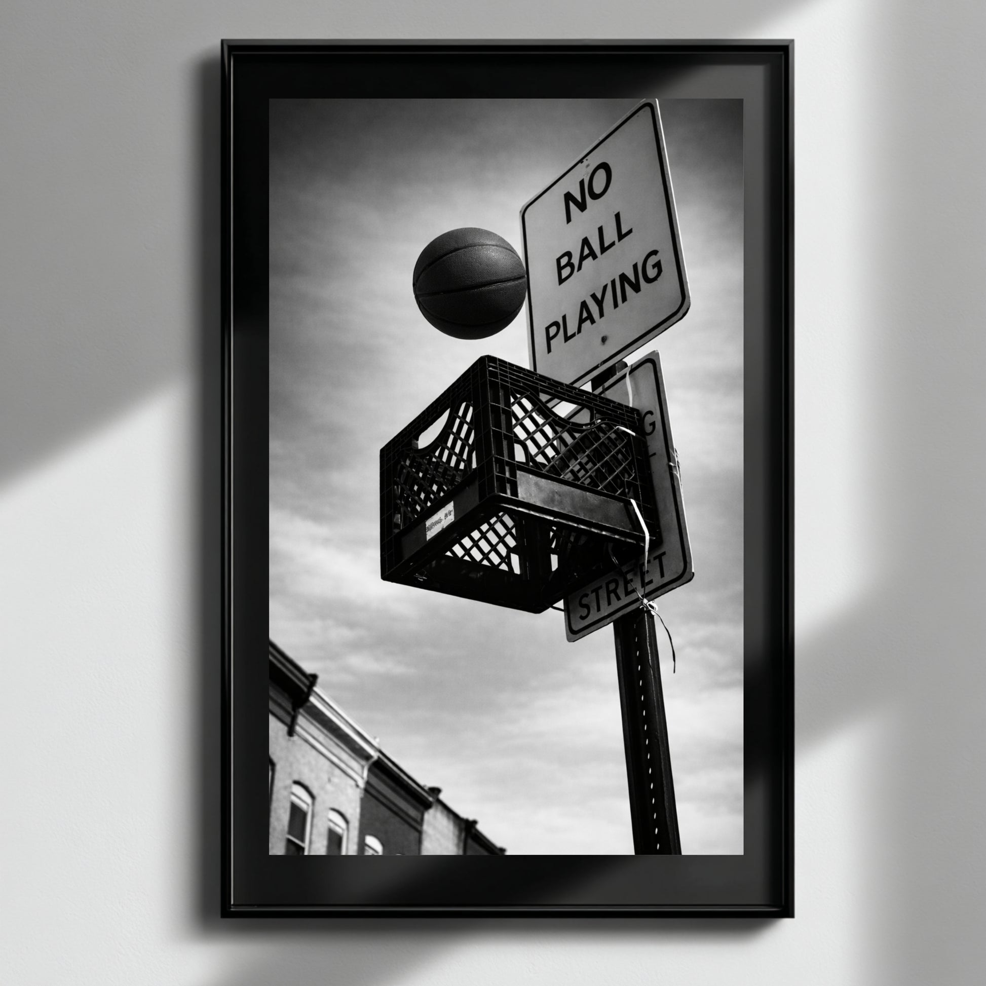 Framed black and white urban basketball artwork with soft light reflection, milk crate hoop and no ball playing sign modern monochrome decor