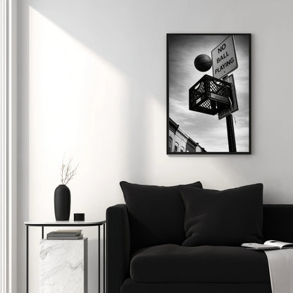 Black and white urban basketball wall art above black couch, milk crate hoop and no ball playing sign modern minimalist interior decor