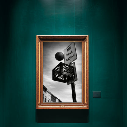 Black and white street basketball wall art framed in ornate gold on emerald green gallery wall, milk crate hoop under “No Ball Playing” sign urban statement decor