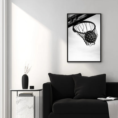Black and white basketball hoop wall art in modern white living room above black sofa, clean minimal sports photography decor