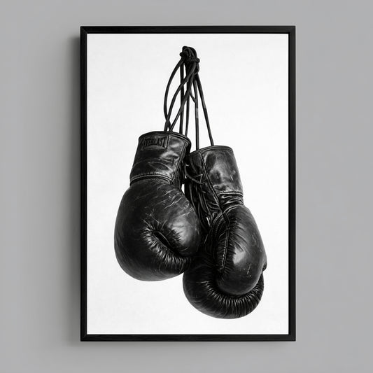 Black and white boxing gloves wall art minimalist sports photography print featuring hanging worn gloves on clean white background