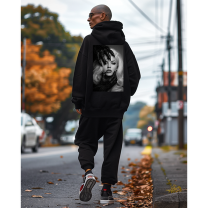 Male model wearing black dark feminine back graphic hoodie outdoors, unisex gothic portrait statement hoodie featuring dark feminine portrait artwork printed on the back